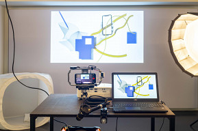 Photography setting with camera, digital technology and projection onto a wall