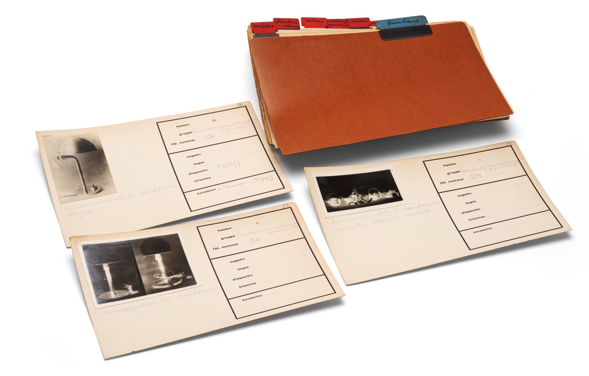 A folder containing images and notes with descriptive maps lies on a table.