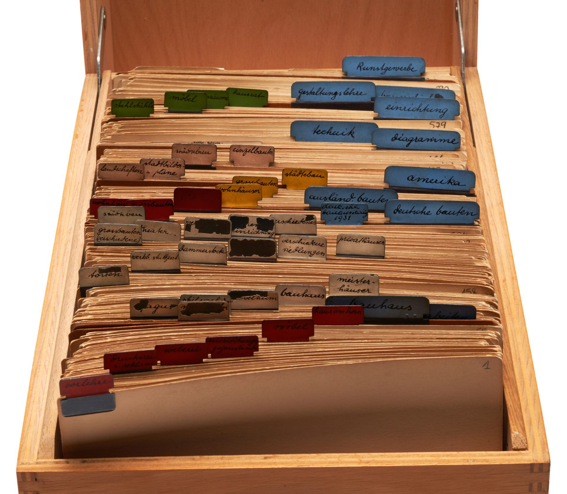 A wooden box with documents, divided by colored labels on the files.