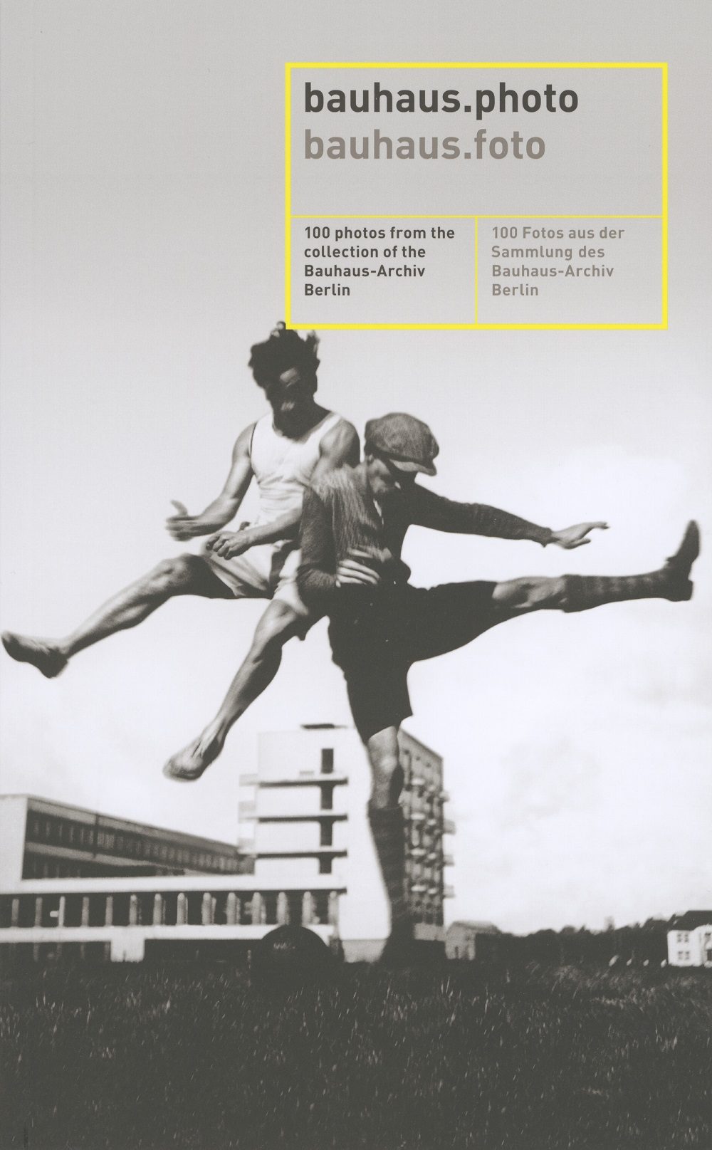 Two dancers in a dynamic pose in front of a modern building, depicted in black and white with yellow text.