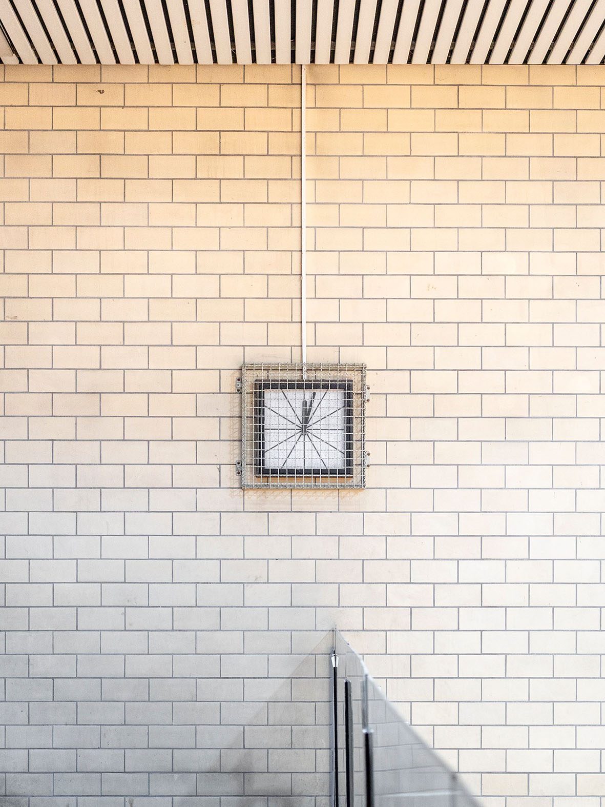 Graphic of a wall with a square, fenced artwork and a minimalist design.