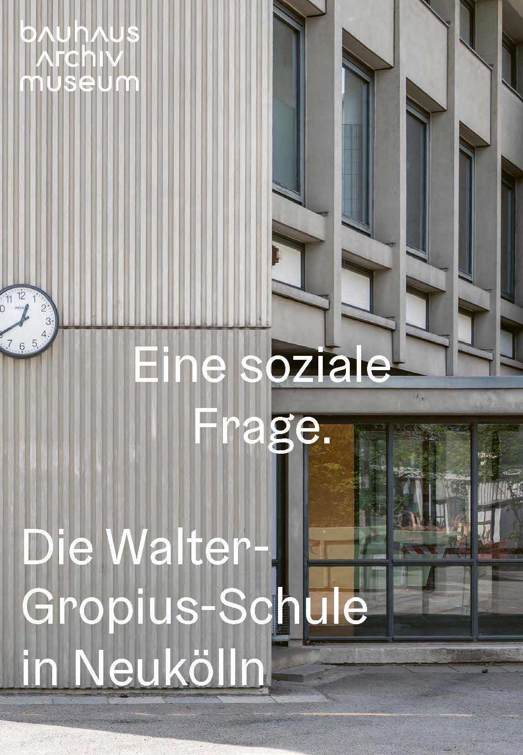 Fassade der Walter-Gropius-Schule in Neukölln mit Uhr und dem Text: "Eine soziale Frage." oben im Bild.