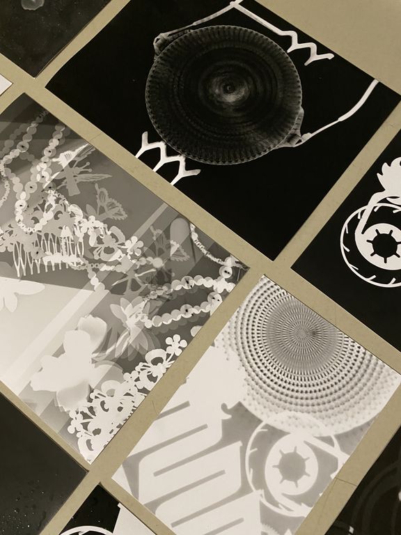 A collage of black-and-white graphics featuring floral and geometric patterns.